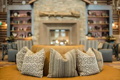 three pillows sitting on a table in a room with a fireplace at Hyatt Vacation Club at The Ranahan in Breckenridge