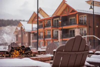 a table and chairs with a fire in front of a house at Hyatt Vacation Club at The Ranahan in Breckenridge