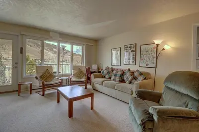 a living room with a couch and a table at CC42 Chateau Claire condo in Dillon