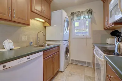 a kitchen with a sink and a washer and dryer at CC42 Chateau Claire condo in Dillon