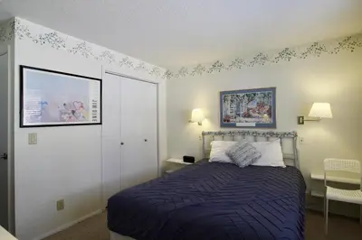 a bedroom with a bed with a blue comforter at CC42 Chateau Claire condo in Dillon