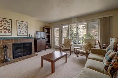 a living room with a couch and a fireplace at CC42 Chateau Claire condo in Dillon