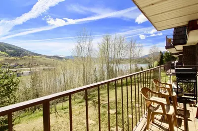 a balcony with a view of a river and mountains at CC42 Chateau Claire condo in Dillon
