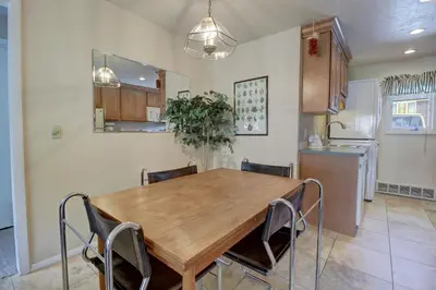 a kitchen and dining room with a wooden table and chairs at CC42 Chateau Claire condo in Dillon