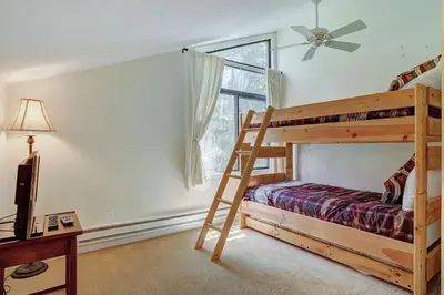 a bedroom with a bunk bed and a window at 1182 Flying Dutchman condo in Keystone