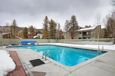 a swimming pool in a yard with a house at 1182 Flying Dutchman condo in Keystone