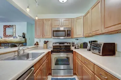 a kitchen with a sink and a stove top oven at 1182 Flying Dutchman condo in Keystone