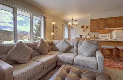 a living room with a couch and a kitchen at CC19 Chateau Claire condo in Dillon