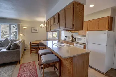 a kitchen with a white refrigerator freezer next to a living room at CC19 Chateau Claire condo in Dillon