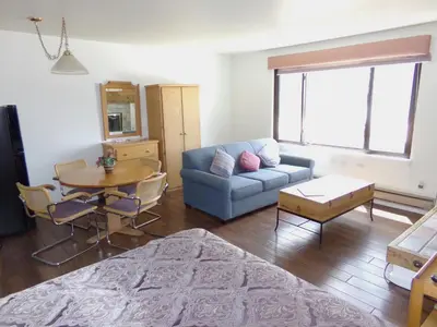 a living room with a couch and a table at Edgewater Studio 1 Bath EWJP in Keystone