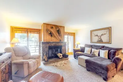 a living room with a couch and a fireplace at Buffalo Village in Silverthorne