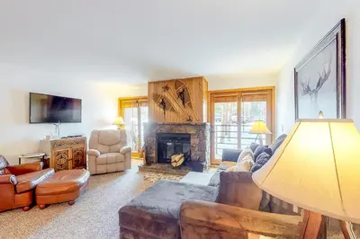 a living room with a couch and a fireplace at Buffalo Village in Silverthorne