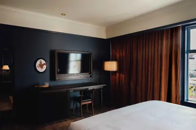 a bedroom with a desk and a tv on a wall at Gravity Haus Denver in Denver
