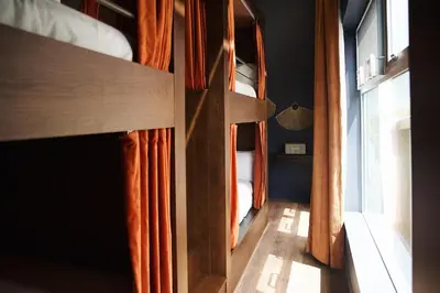 a room with two bunk beds and a window at Gravity Haus Denver in Denver