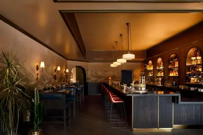 a restaurant with a bar with tables and chairs at Gravity Haus Denver in Denver