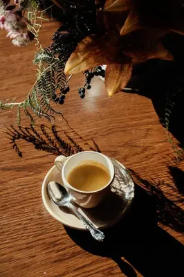 a cup of coffee on a table with a spoon at Gravity Haus Denver in Denver