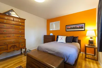 a bedroom with a bed with an orange wall at Fantastic Classic Family Home in Boulder