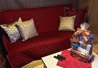 a red couch with pillows and a box of presents at Fantastic Classic Family Home in Boulder