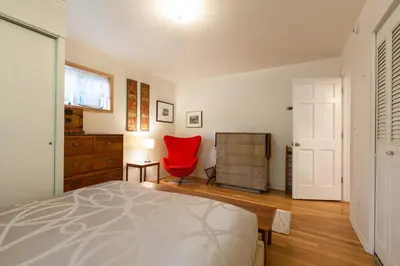 a bedroom with a bed and a red chair at Fantastic Classic Family Home in Boulder