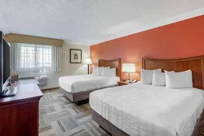 a hotel room with two beds and a flat screen tv at Best Western Plus Loveland Inn in Loveland