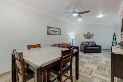 a living room with a table and chairs and a couch at Best Western Plus Loveland Inn in Loveland