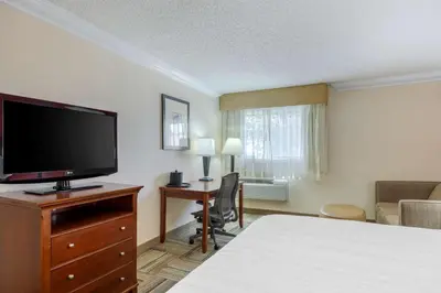 a hotel room with a bed and a flat screen tv at Best Western Plus Loveland Inn in Loveland