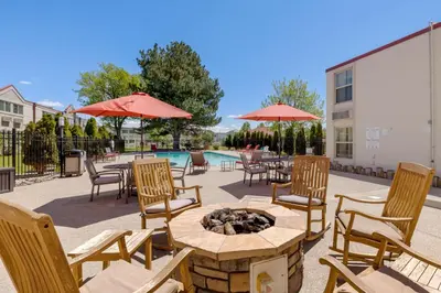 a patio with tables and chairs and a fire pit at Best Western Plus Loveland Inn in Loveland