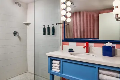 a bathroom with a sink and a shower at the Curtis Denver - A DoubleTree by Hilton Hotel in Denver