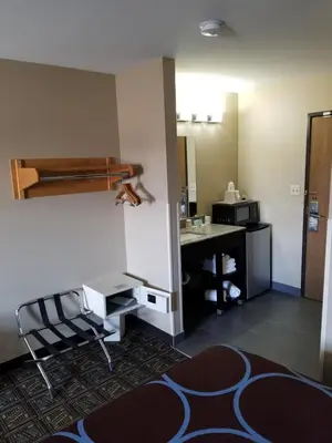 a hotel room with a desk and a bunk bed at Super 8 by Wyndham Fort Collins in Fort Collins