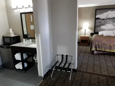 a hotel room with a bed and a sink at Super 8 by Wyndham Fort Collins in Fort Collins