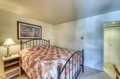 a bedroom with a bed and a lamp on a night stand at Wild Irishman 1080 in Dillon