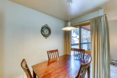 a dining room table with chairs and a clock on the wall at Wild Irishman 1080 in Dillon