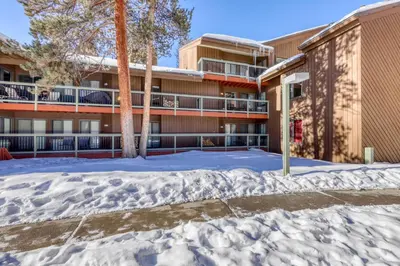 a snow covered parking lot in front of a building at Wild Irishman 1080 in Dillon