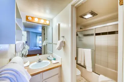 a bathroom with a sink and a toilet and a mirror at Wild Irishman 1080 in Dillon