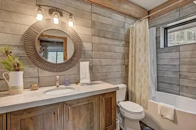 a bathroom with a sink and a toilet and a mirror at SkyRun Cabin cabin in Golden