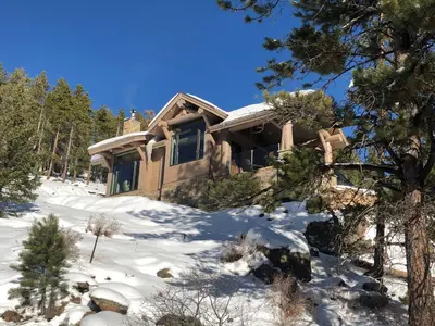 a house in the snow in the woods at SkyRun Cabin cabin in Golden