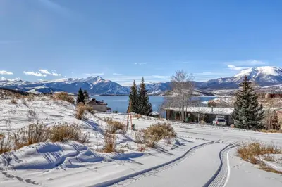 a road covered in snow with mountains in the background at 615 Oro Grande in Dillon