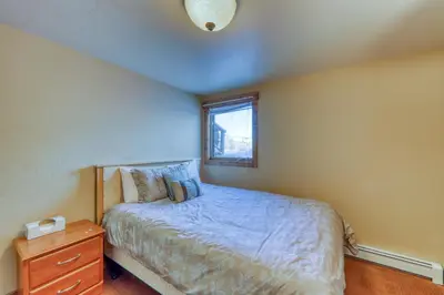 a small bedroom with a bed and a window at 615 Oro Grande in Dillon