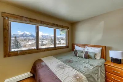 a bedroom with a bed and a window with a mountain view at 615 Oro Grande in Dillon
