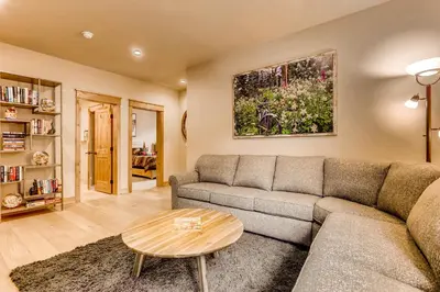 a living room with a couch and a table at Three-Bedroom Townhouse in Keystone
