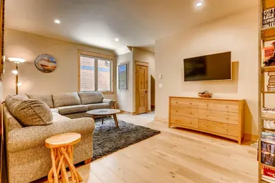 a living room with a couch and a tv at Three-Bedroom Townhouse in Keystone