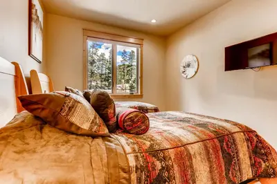 a room with a bed with pillows on it at Three-Bedroom Townhouse in Keystone
