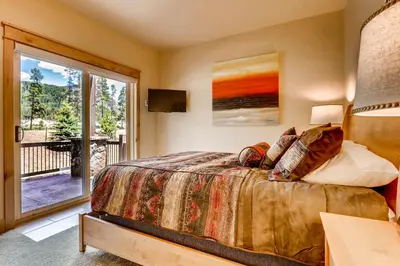 a bedroom with a bed and a large window at Three-Bedroom Townhouse in Keystone