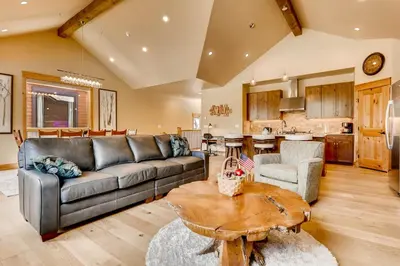 a living room with a couch and a table at Three-Bedroom Townhouse in Keystone