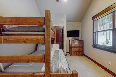 a bedroom with two bunk beds and a television at Keystone Townhome in Keystone