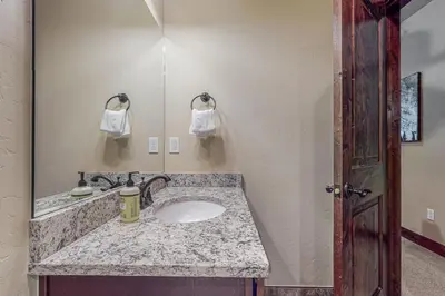 a bathroom with a sink and a mirror at Keystone Townhome in Keystone