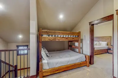 a bedroom with two bunk beds and a mirror at Keystone Townhome in Keystone