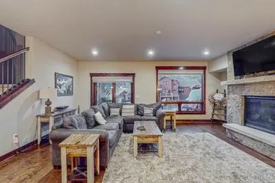 a living room with a couch and a fireplace at Keystone Townhome in Keystone