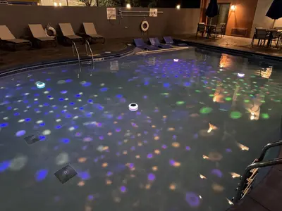 a swimming pool with blue and green lights in it at Holiday Inn Express Denver Central - North in Denver