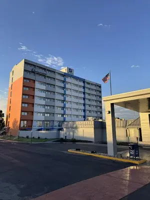a large building with a flag in front of it at Holiday Inn Express Denver Central - North in Denver